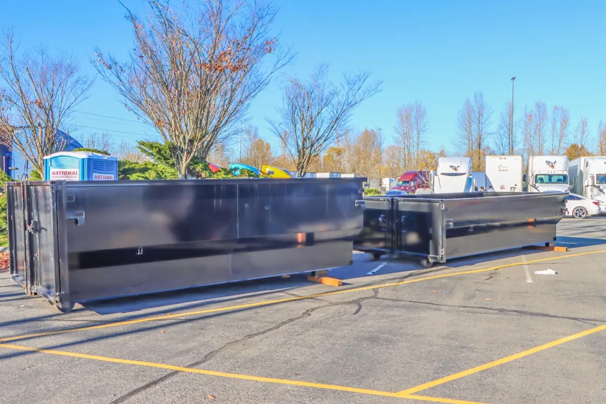 Professional dumpster rental service with roll-off container on residential driveway in Irondequoit